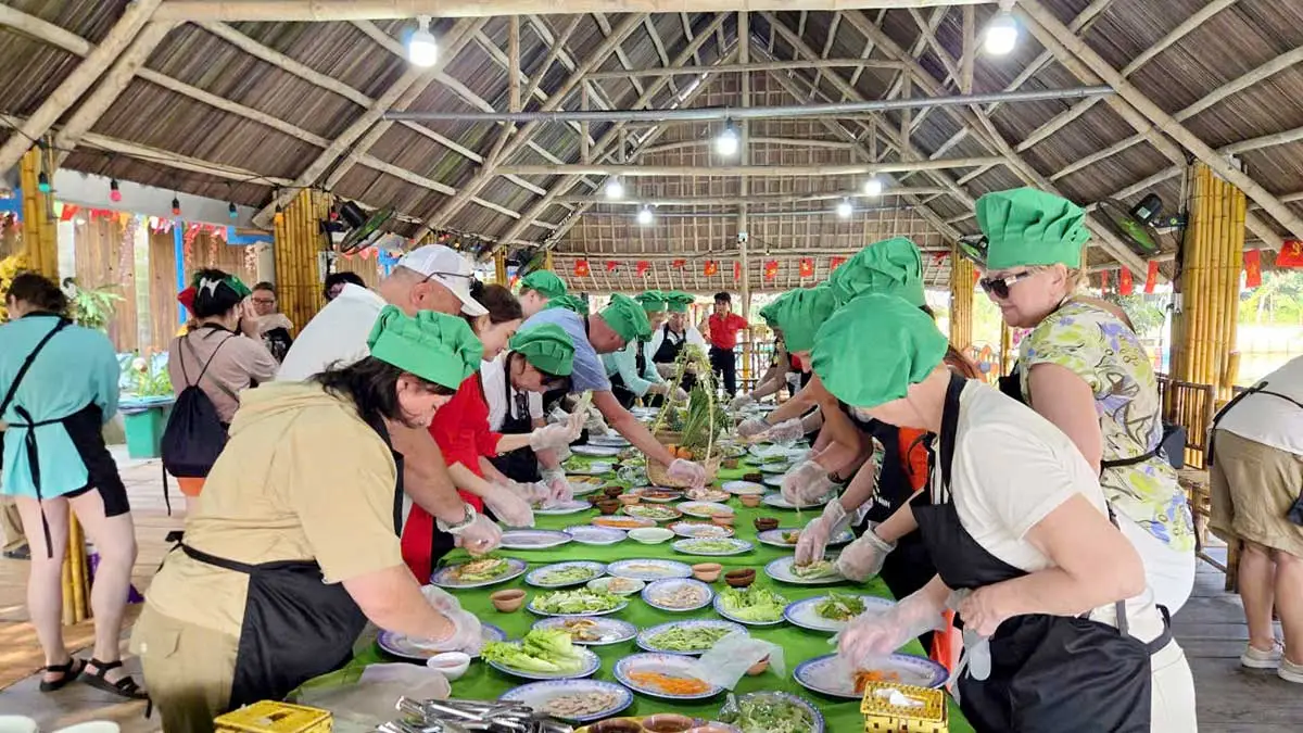 Visitors enjoying a Vietnamese cooking class in Hoi An